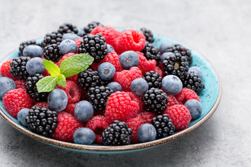 Fresh raspberries in a plate on a  vintage background.