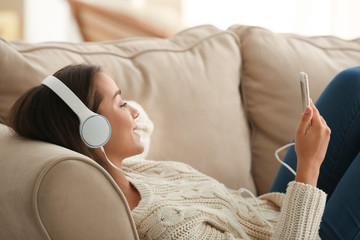 Poster - Beautiful young woman listening to music at home