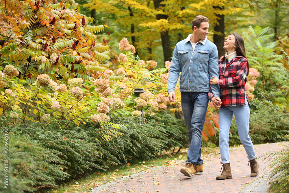 Loving young couple on romantic date in autumn park