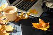 © Pixel-Shot - Laptop with coffee, book and autumn leaves on wooden table