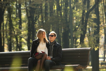 Wall Mural - couple people young man and women walking autumn park fanny sunny day