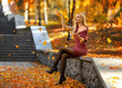 Girl with perfect legs playing with fallen leaves