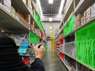 businessman hand holding tablet technology check products storage factory and warehouse