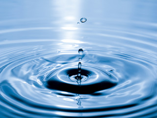 close up drop of water on blue background