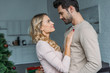 © LIGHTFIELD STUDIOS - affectionate couple hugging in kitchen and looking at each other