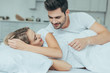 © LIGHTFIELD STUDIOS - beautiful young couple cuddling in bed at home