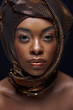 © LIGHTFIELD STUDIOS - portrait of stylish african american model with head wrap isolated on black