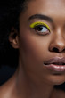 © LIGHTFIELD STUDIOS - partial view of african american model with bright neon eye shadow isolated on black