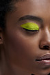 © LIGHTFIELD STUDIOS - partial view of african american model with bright neon eye shadow