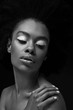 © LIGHTFIELD STUDIOS - black and white photo of attractive african american woman isolated on black