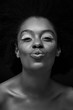 © LIGHTFIELD STUDIOS - black and white photo of attractive african american woman with duck face isolated on black