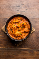 Wall Mural - Murgh Makhani / Butter chicken tikka masala served with roti / Paratha and plain rice along with onion salad. selective focus