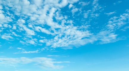 Blue skies with a fluffy white clouds.