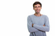 © Ranta Images - Studio shot of happy young handsome man smiling with arms crosse