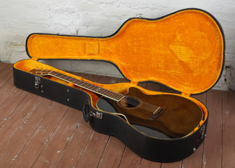 Musical instrument - brown cutaway acoustic guitar in hard case