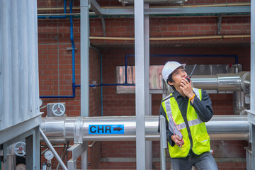 Asian Maintenance engineer at the waste water management system of a huge factory,maintenance checking technical data of heating system equipment,Thailand people