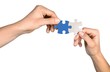 © BillionPhotos.com - Closeup on Hands Combining Puzzle Pieces Together