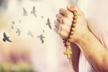 Woman praying and free birds enjoying nature on sunset