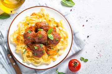 Sticker - Meatballs in tomato sauce with pasta tagliatelle top view.