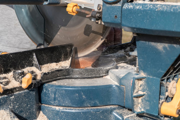 Roof construction building. Work on circular saw. Sawing wooden elements.