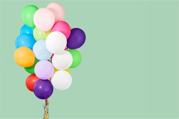 bunch of colorful balloons on pastel background