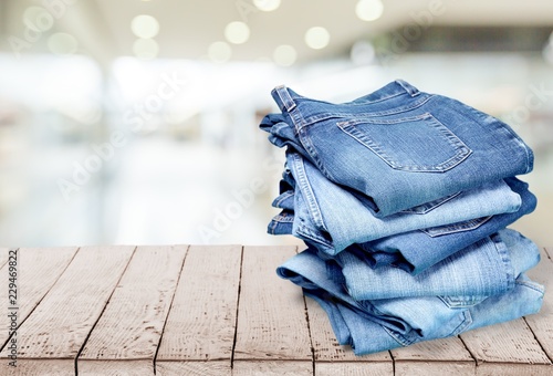 Tela Stack of jeans isolated on white background