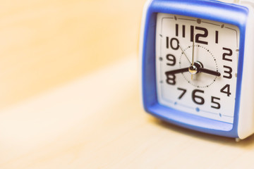 Blue and white square analog clock. Space for text.