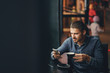 © prostooleh - man using phone inside a restaurant