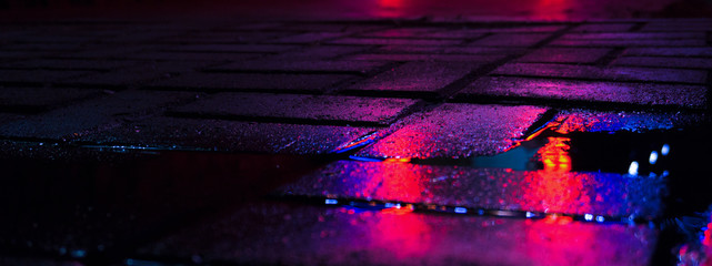 Wall Mural - Background of wet asphalt with neon light. Blurred background, night lights of a big city, reflection, puddles. Dark neon bokeh.