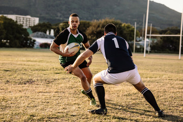 Wall Mural - Rugby players tackling during game