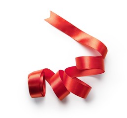 Red ribbon nicely uncurled, isolated on pure white. Preparation for gift wrapping.