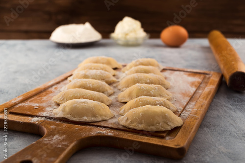 Raw Dumplings With Cottage Cheese Filling Laid On The Kitchen