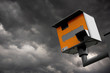 YELLOW GATSO ROAD SAFETY SPEED CAMERA AGAINST STORMY GREY SKY