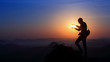 © Nandhu - Silhouette of man holding sun on the mountain