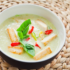 Wall Mural - Vegan Thai Green Curry with fried firm tofu pieces, sesonal vegetable, red bird's eye chili and sweet basil. 