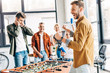 © LIGHTFIELD STUDIOS - expressive casual business people playing table football at office and having fun together
