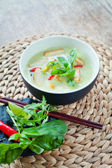 Wall Mural - Vegan Thai Green Curry with fried firm tofu pieces, sesonal vegetable, red bird's eye chili and sweet basil. 