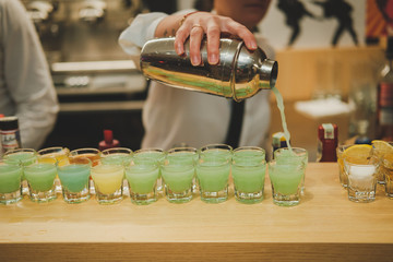 Wall Mural - waiter serving shots in a bar