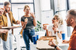 © LIGHTFIELD STUDIOS - group of successful entrepreneurs having pizza for lunch together while working on startup at office