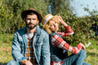 © LIGHTFIELD STUDIOS - selective focus of couple of farmers sitting on grass outdoors