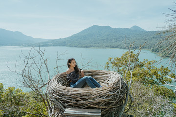 Wall Mural - woman enjoying nature from top of the hill