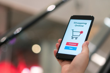 Online shopping with smartphone and shopping bags delivery service using as background shopping concept and delivery service concept with copy space  for your text or  design.