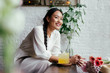 © LUMINA IMAGES - Smiling young woman with braided hair sitting at cafe