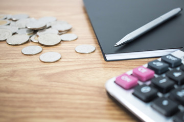 Close up the coin and put a pen on the desk of a businessman. Business Concepts.