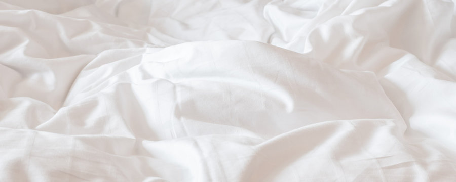 white bed sheet blanket, wrinkled duvet, crumpled comforter cloth used in hotel, resort or home inte