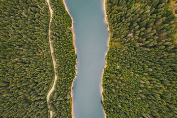 Lake in the middle of the forest as seen from above. Bolboci Lake, Carpathian Mountains, Romania