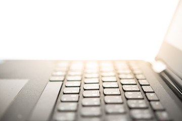 close up of laptop keyboard on white background.