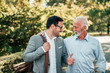 © bnenin - Two friendly businessman walking outdoors.