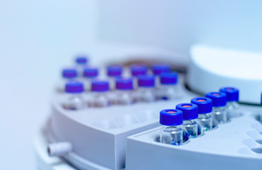 Wall Mural - blue shade picture of close up vials in autosampler of gas chromatography with spectrometer in chemi