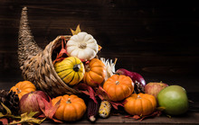 A Thanksgiving Holiday Decorative Cornucopia With Pumpkins, Squash, Leaves Etc